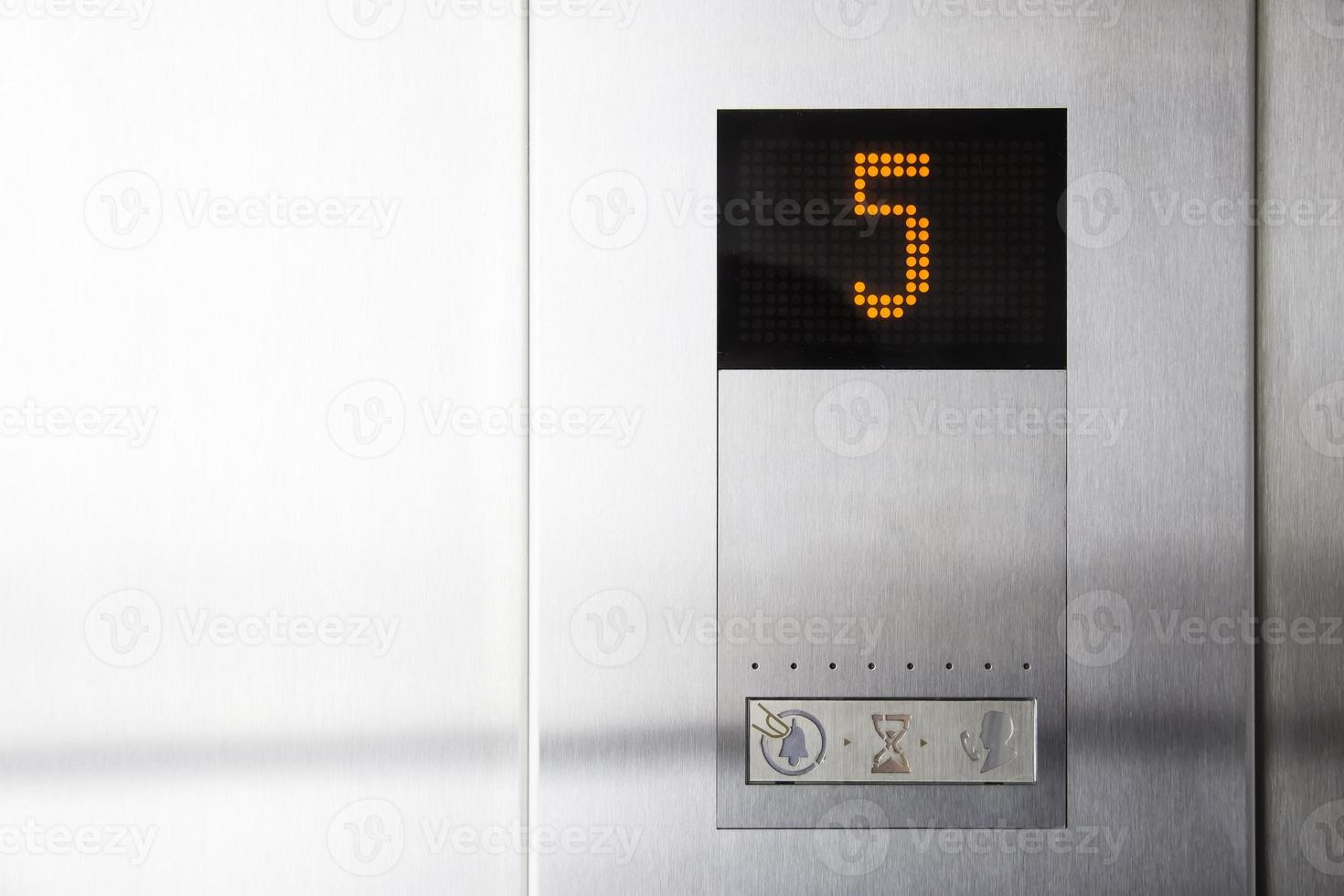 Floor number five on electronic LCD display in elevator of modern business center photo