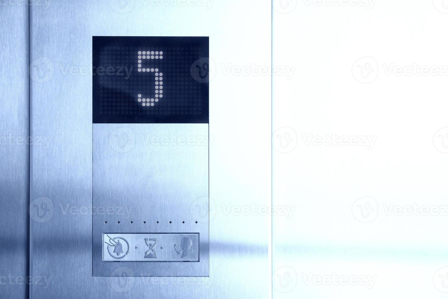 In metal elevator LCD display shows number of fifth floor photo