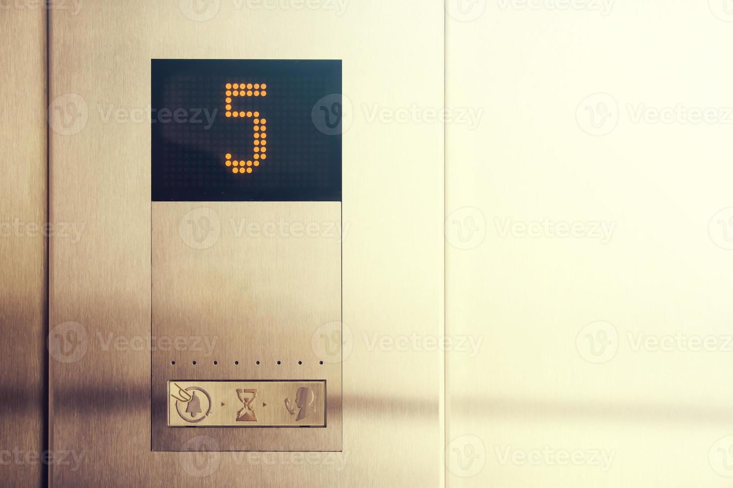 In elevator of modern business center on electronic LCD display shows number 5 floor photo