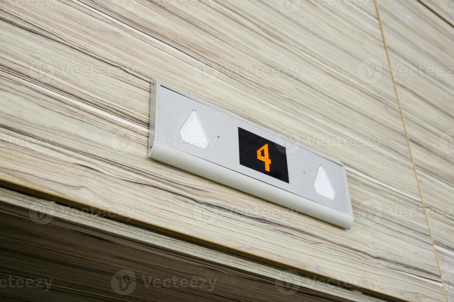 Above elevator door electronic digital display with number four floor photo