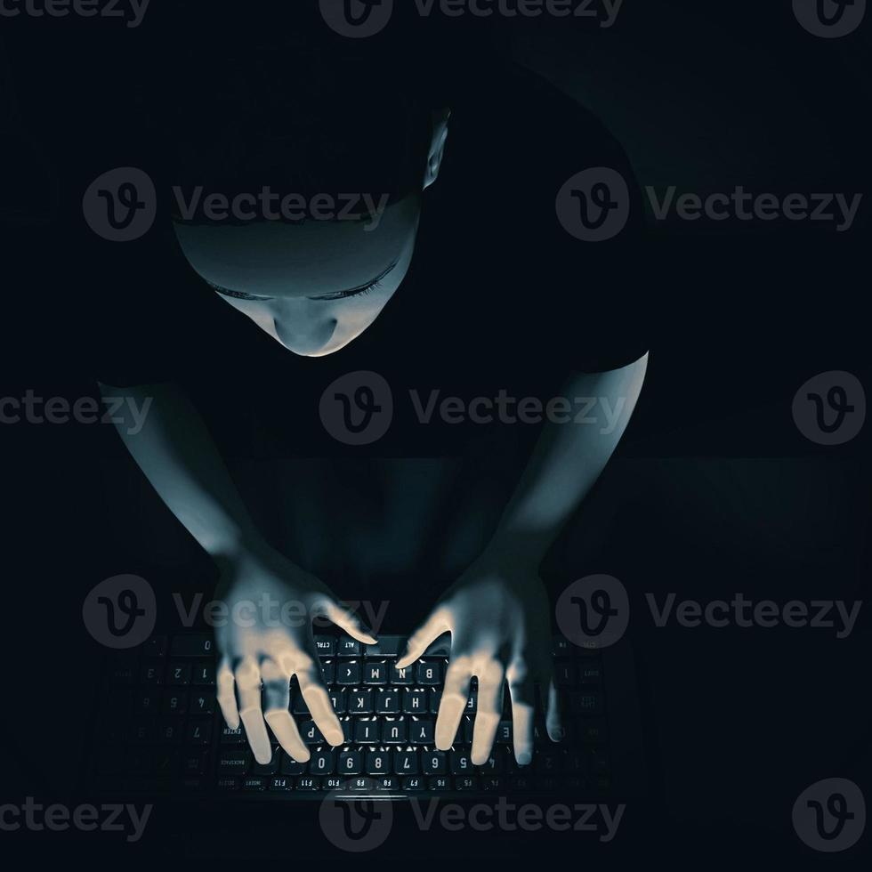 Young man sitting at a computer in the dark. 3d render photo