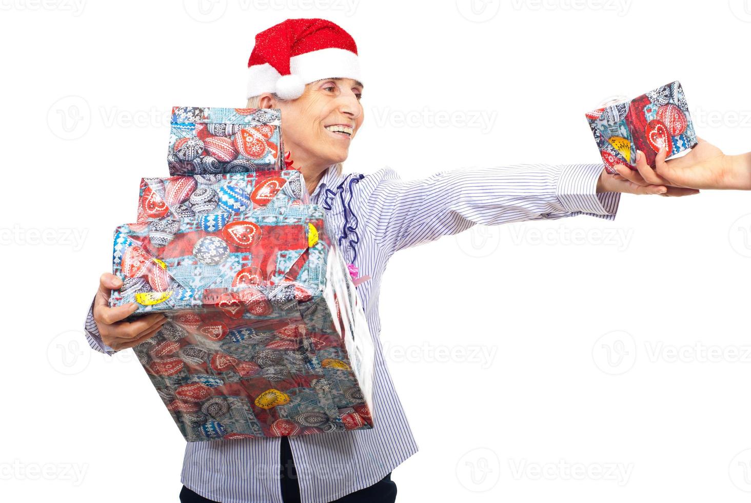 Senior woman holding Christmas presents photo