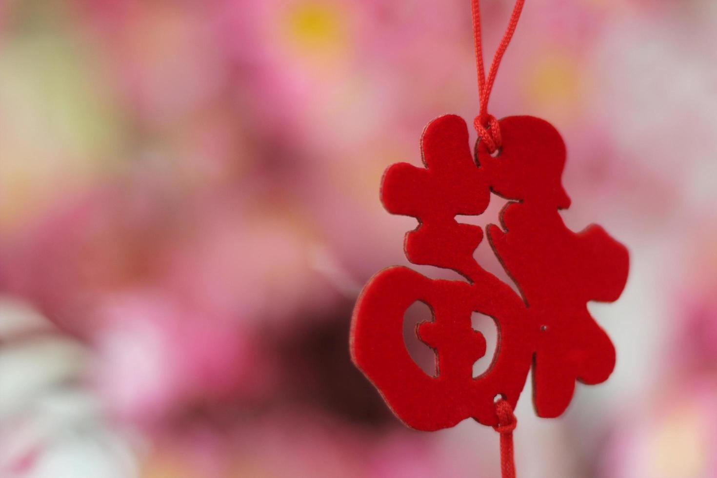 Pink Cherry Blossoms with Chinese ornaments on a blur cafe background photo