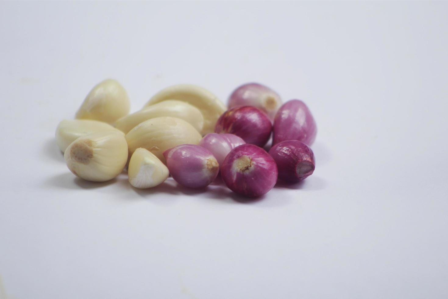 a collection of kitchen spices called garlic and onion mixed on a white background photo