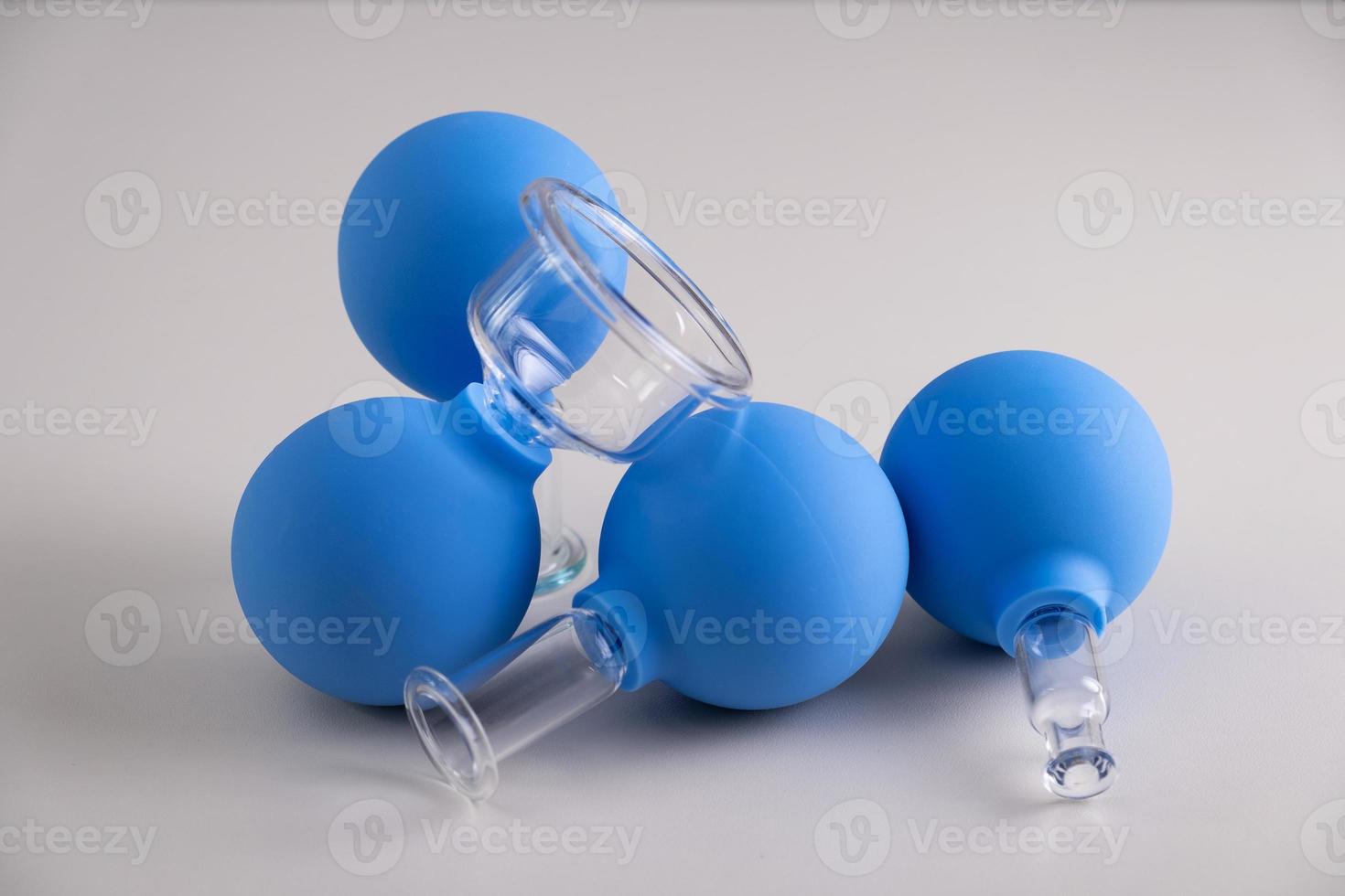 Vacuum pot for vacuum facial massage stands on a wooden table photo
