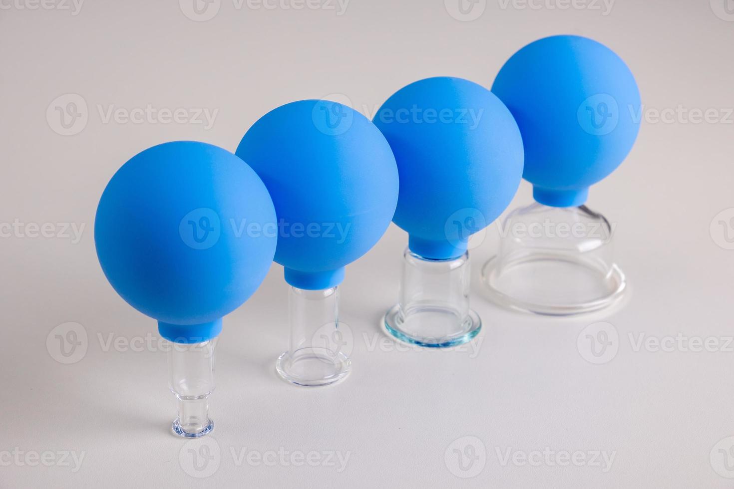 Vacuum pot for vacuum facial massage stands on a wooden table photo