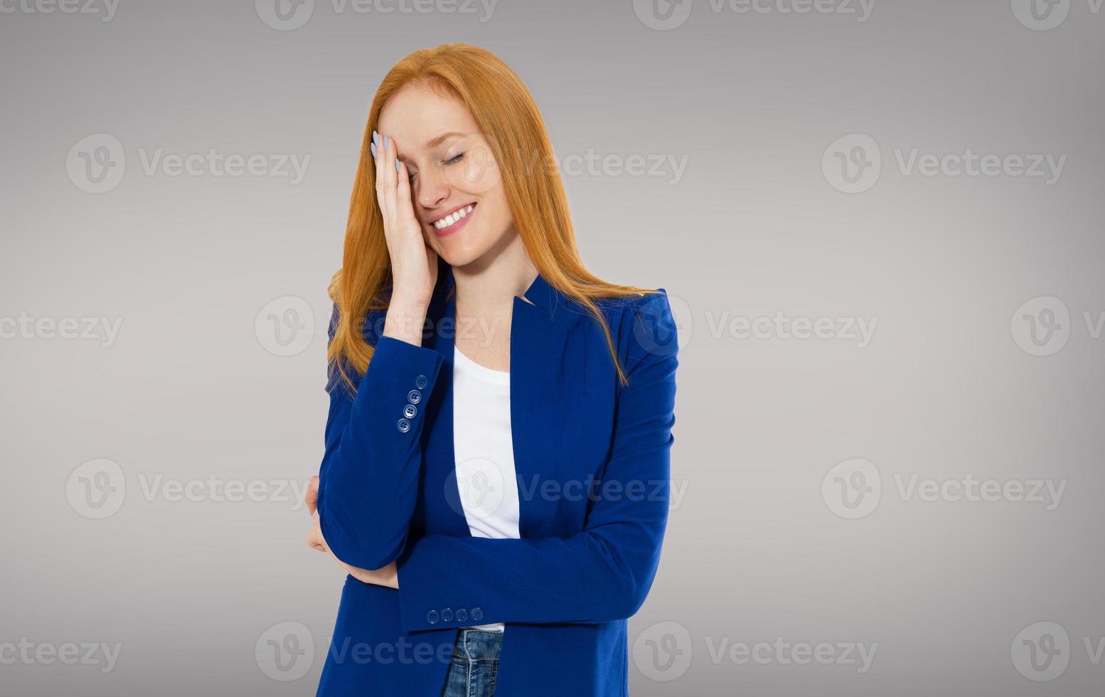 Tired red-haired girl holds her head with a migraine head - girl woman head ache, head pain photo