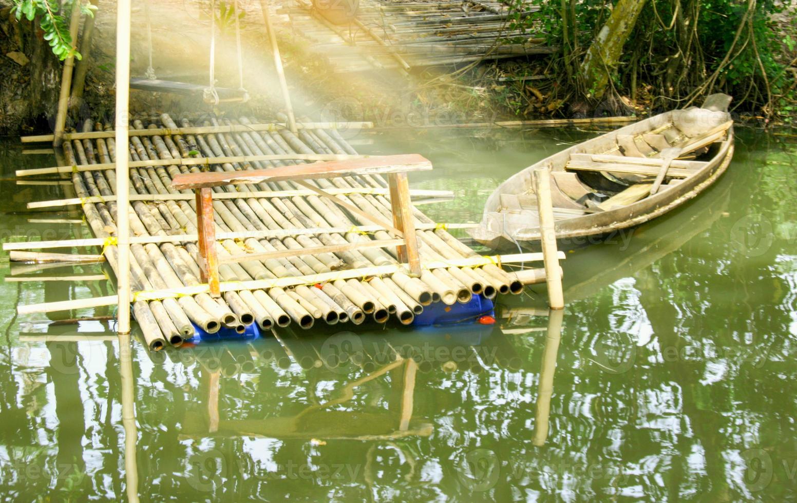 light morning and wooden boat moored a at resortt the water in the resort in thailand photo