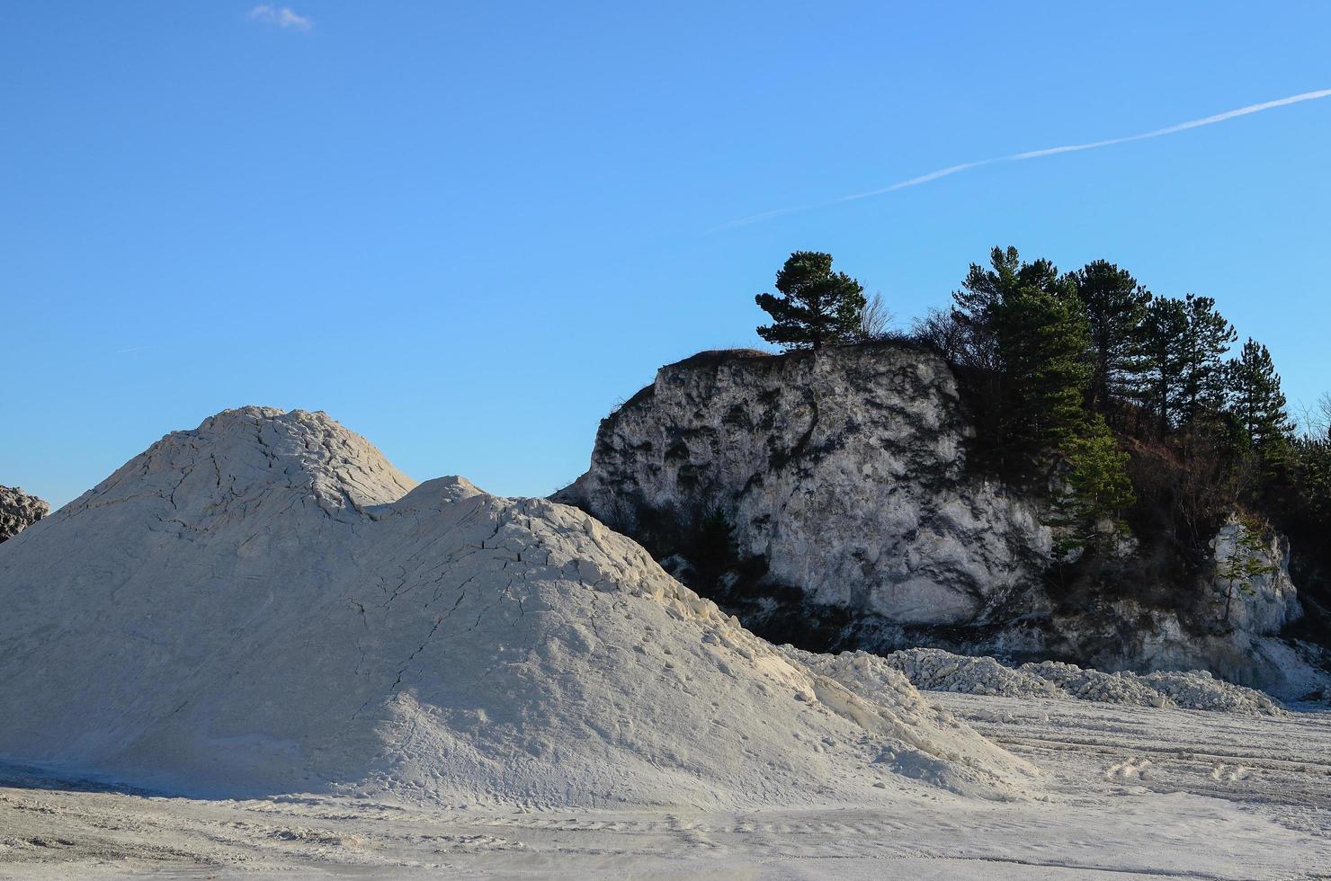 white chalk quarry and green trees photo