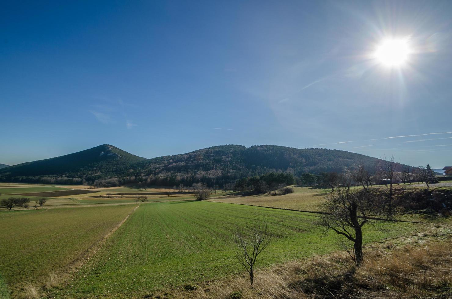 wide landscape with mountains and sun photo