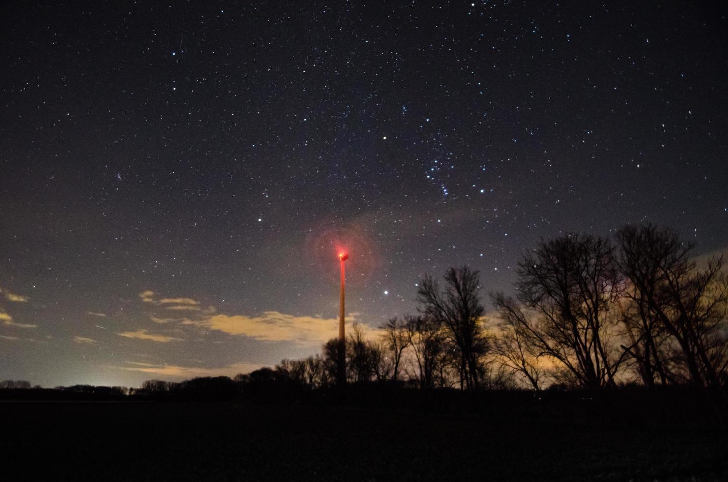 windmill at trees and starry sky photo