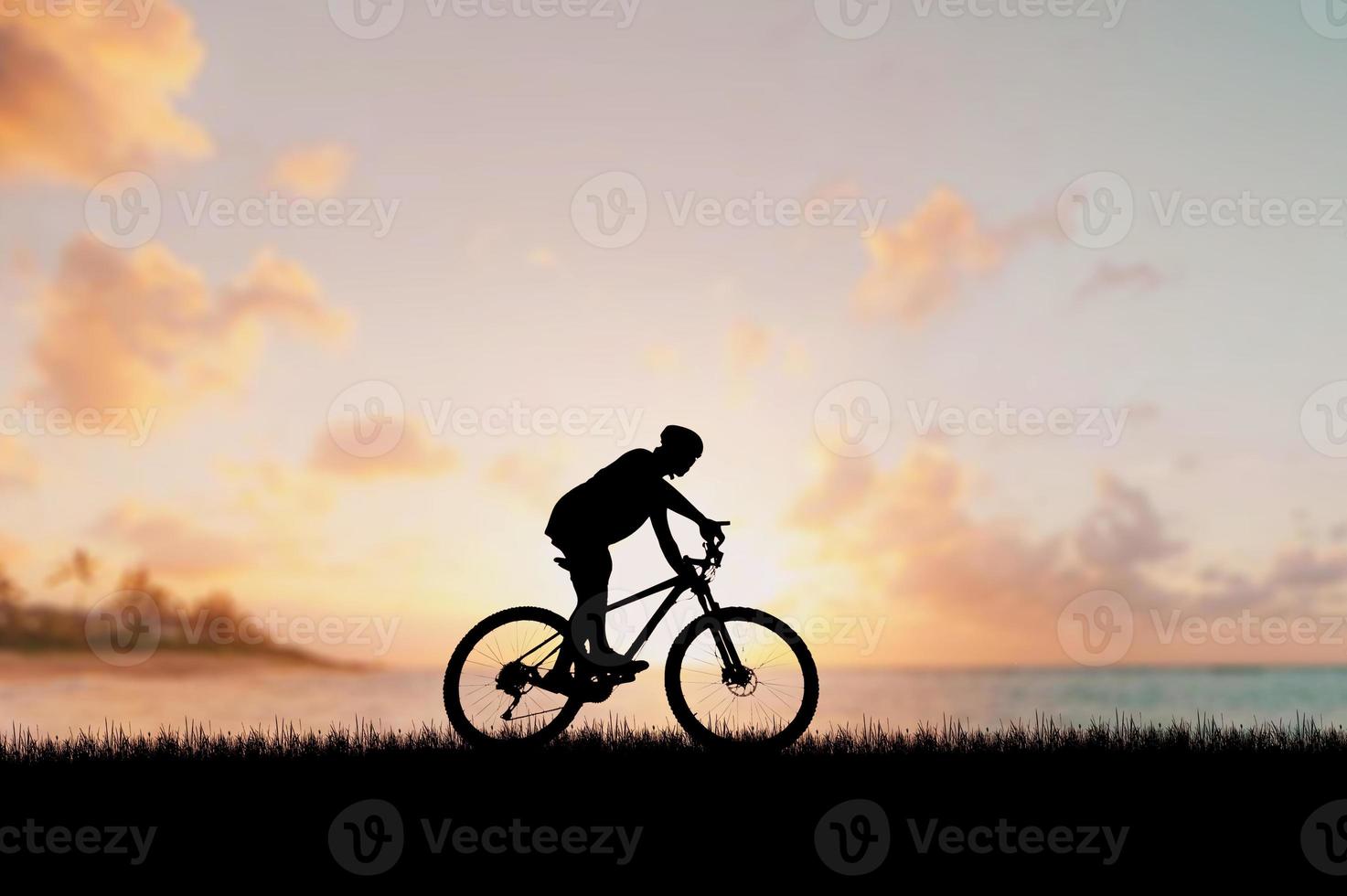 Silhouette of a cyclist in a beautiful evening meadow. bike vacation ideas photo