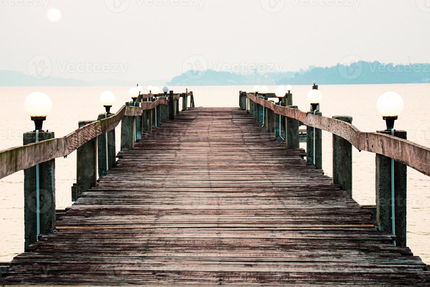 A wooden walkway that stretches into the sea. vacation travel concept photo