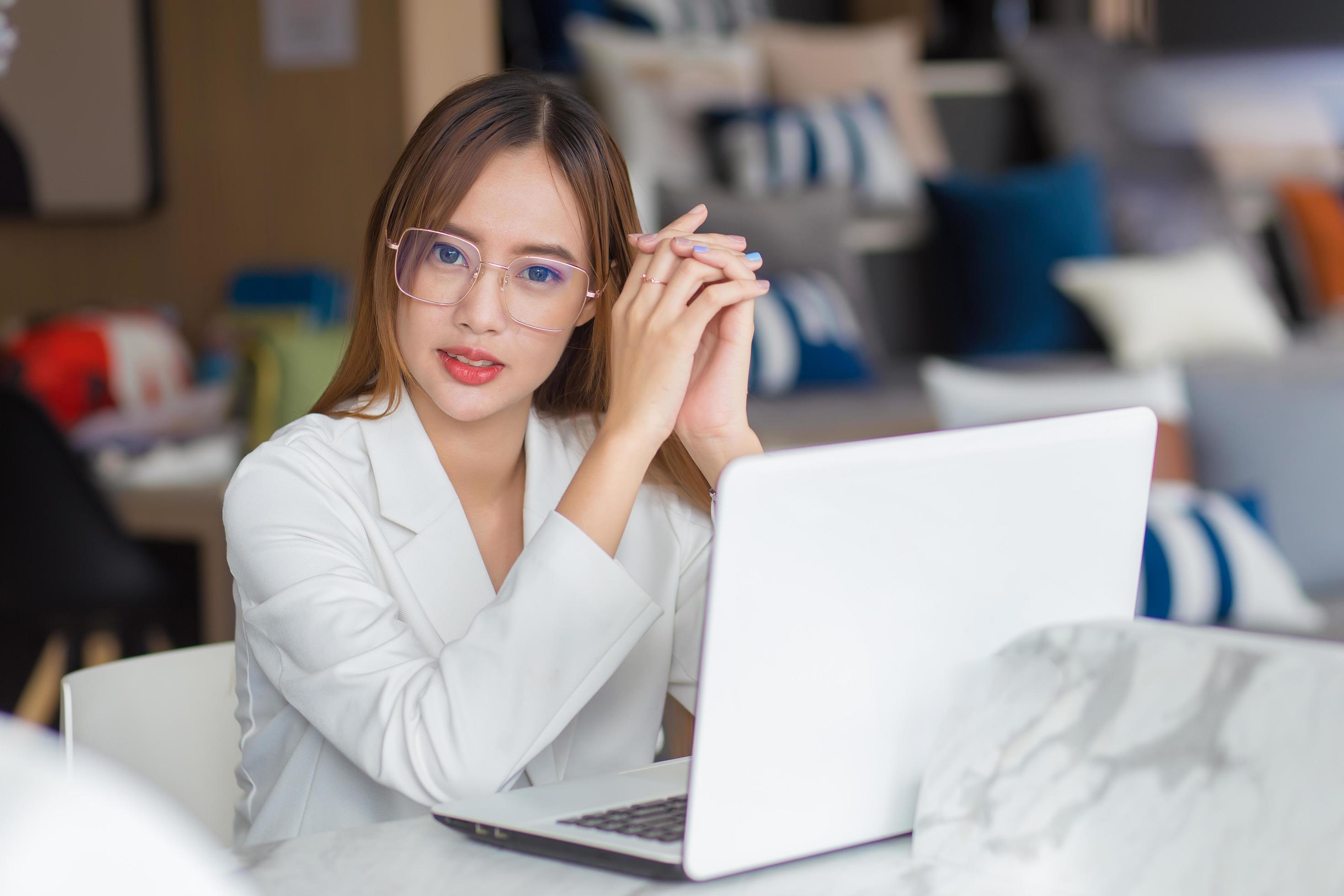 Asian professional business woman wearing glasses works while looking