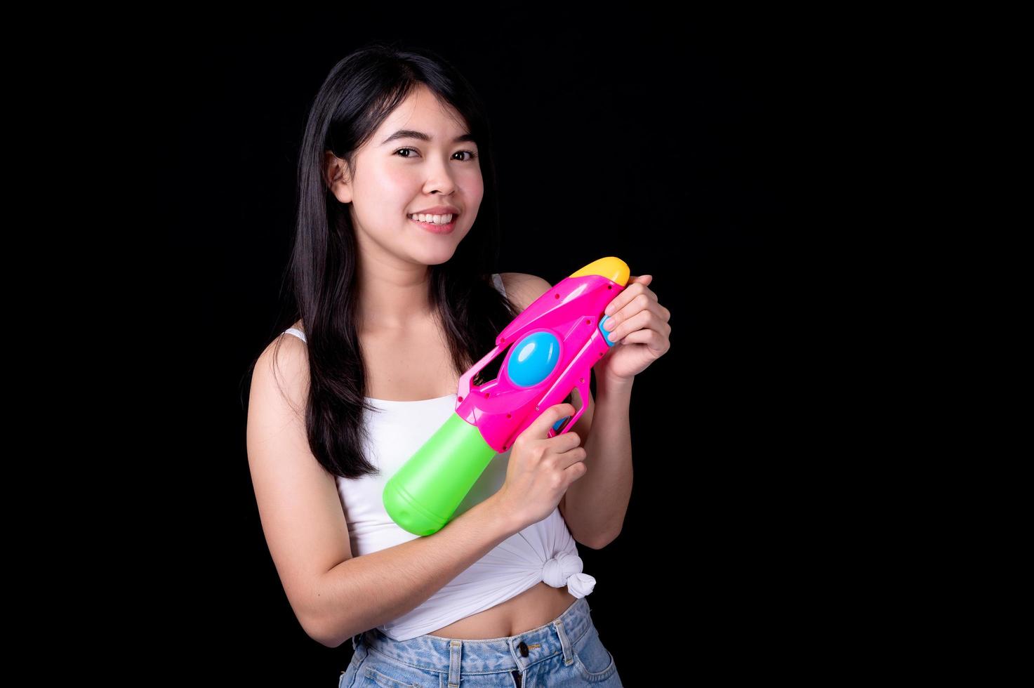 Beautiful Asian women hold plastic water guns at an ancient temple during Songkran, the most beautiful and fun water festival in Thailand photo