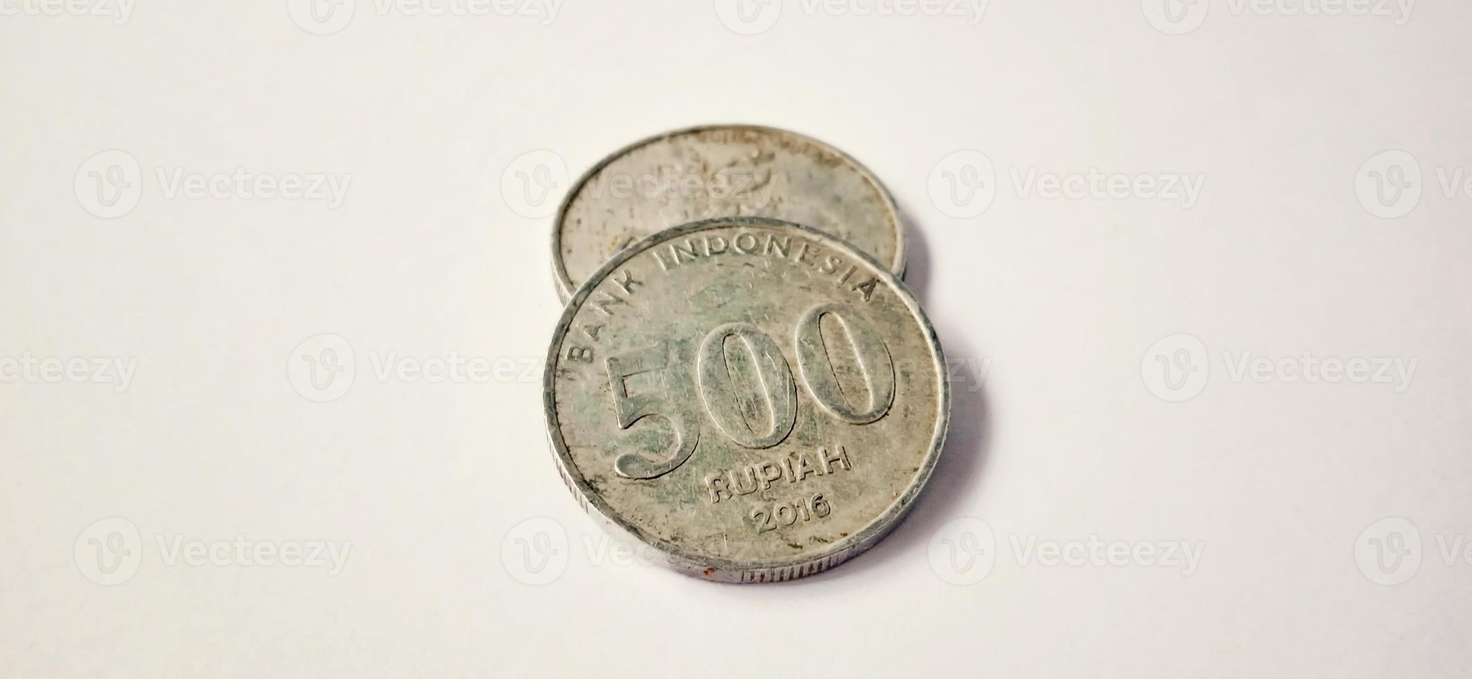 Two side of old 500 rupiah coin from Bank Indonesia with a grey background. Made of year is 2016. Indonesian rupiah, 500 Rupiah, Indonesian currency, Indonesian money background. photo