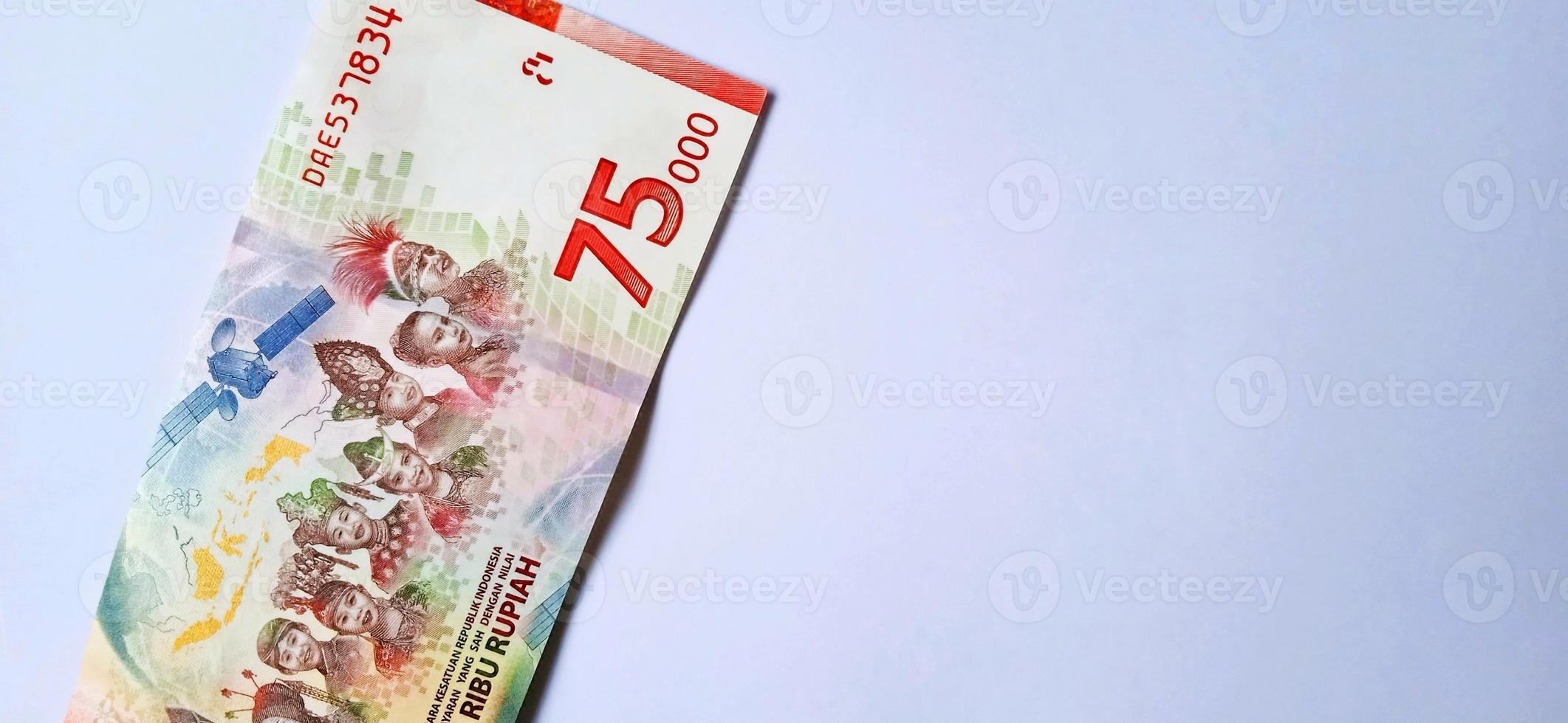 A new 75,000 rupiah banknote from Bank Indonesia with a grey background. Issued during the 75 th national independent of Indonesia at 17 August 2020, period of 1945-2020. Indonesian currency. photo