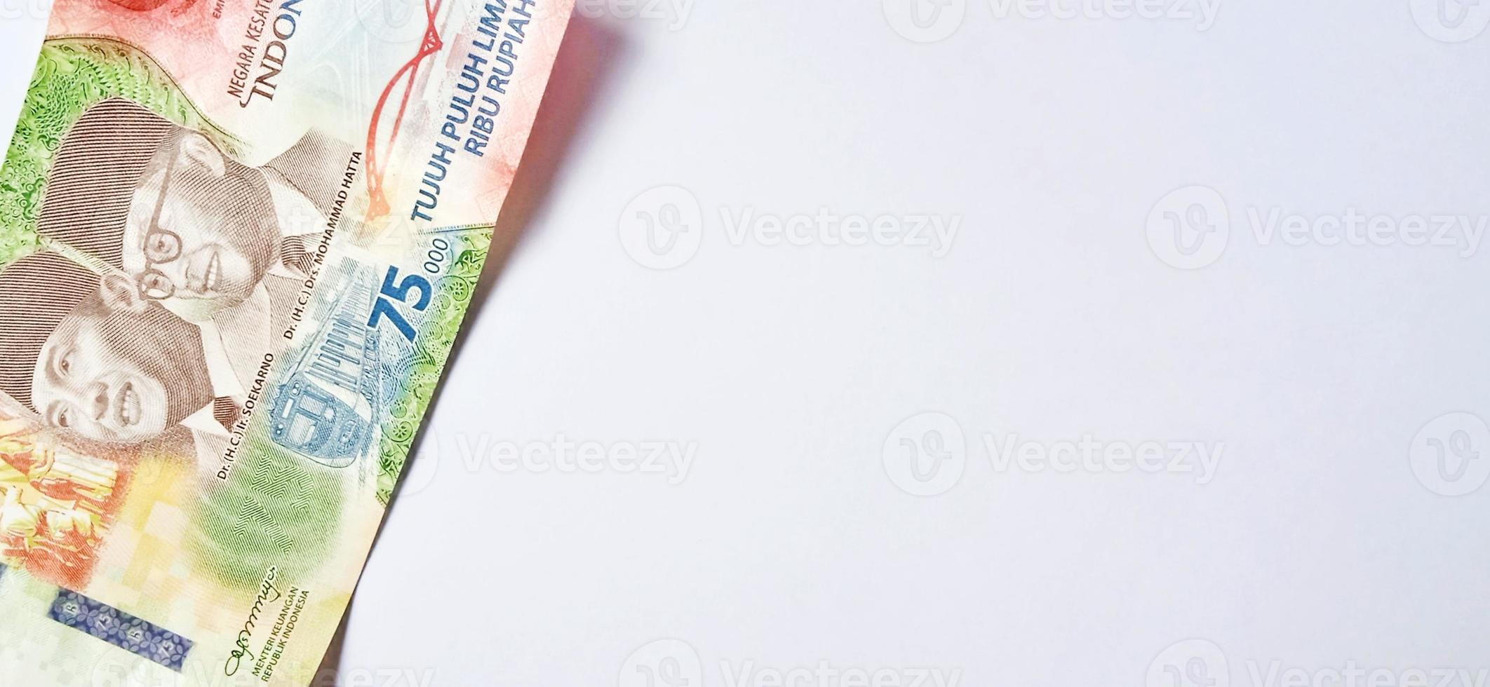 A new 75,000 rupiah banknote from Bank Indonesia with a grey background. Issued during the 75 th national independent of Indonesia at 17 August 2020, period of 1945-2020. Indonesian currency. photo