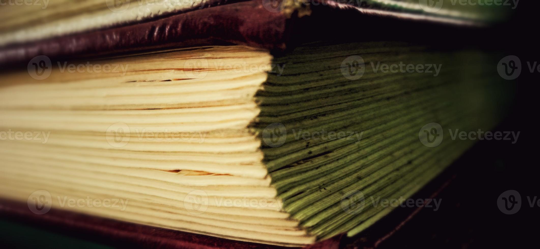 Paper layers in the old book with a dim or dark background. Suitable for private and commercial advertising of library, office, campus, and school informations. photo