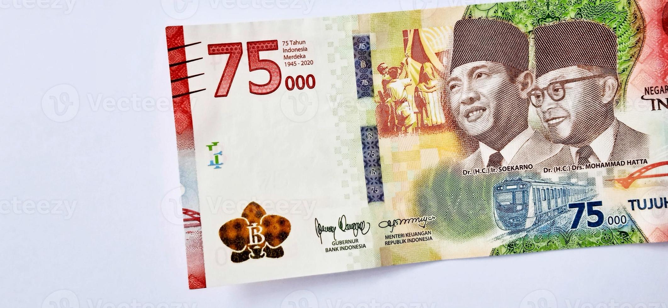 A new 75,000 rupiah banknote from Bank Indonesia with a grey background. Issued during the 75 th national independent of Indonesia at 17 August 2020, period of 1945-2020. Indonesian currency. photo
