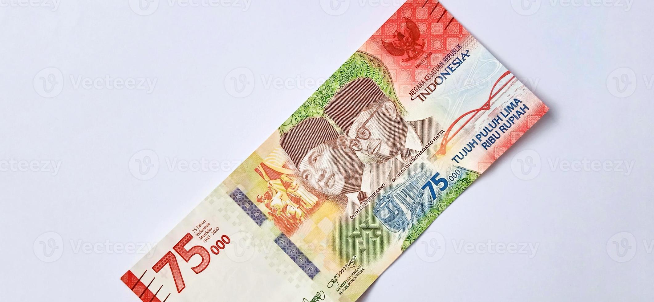 A new 75,000 rupiah banknote from Bank Indonesia with a grey background. Issued during the 75 th national independent of Indonesia at 17 August 2020, period of 1945-2020. Indonesian currency. photo