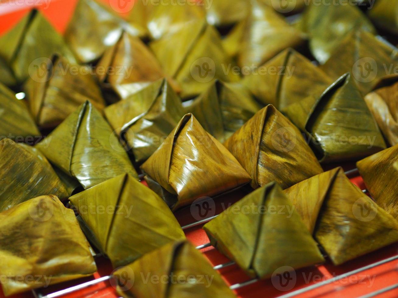 Stuffed Dough Pyramid Dessert Stuffed Dough Pyramid, year cake, Chinese New Year cake, dessert Made with glutinous rice flour and sugar put banana leave small basket and steamed cooked photo