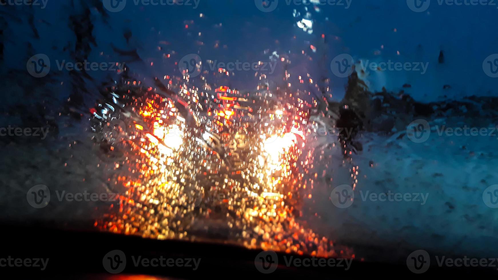 Car lights through wet glass photo