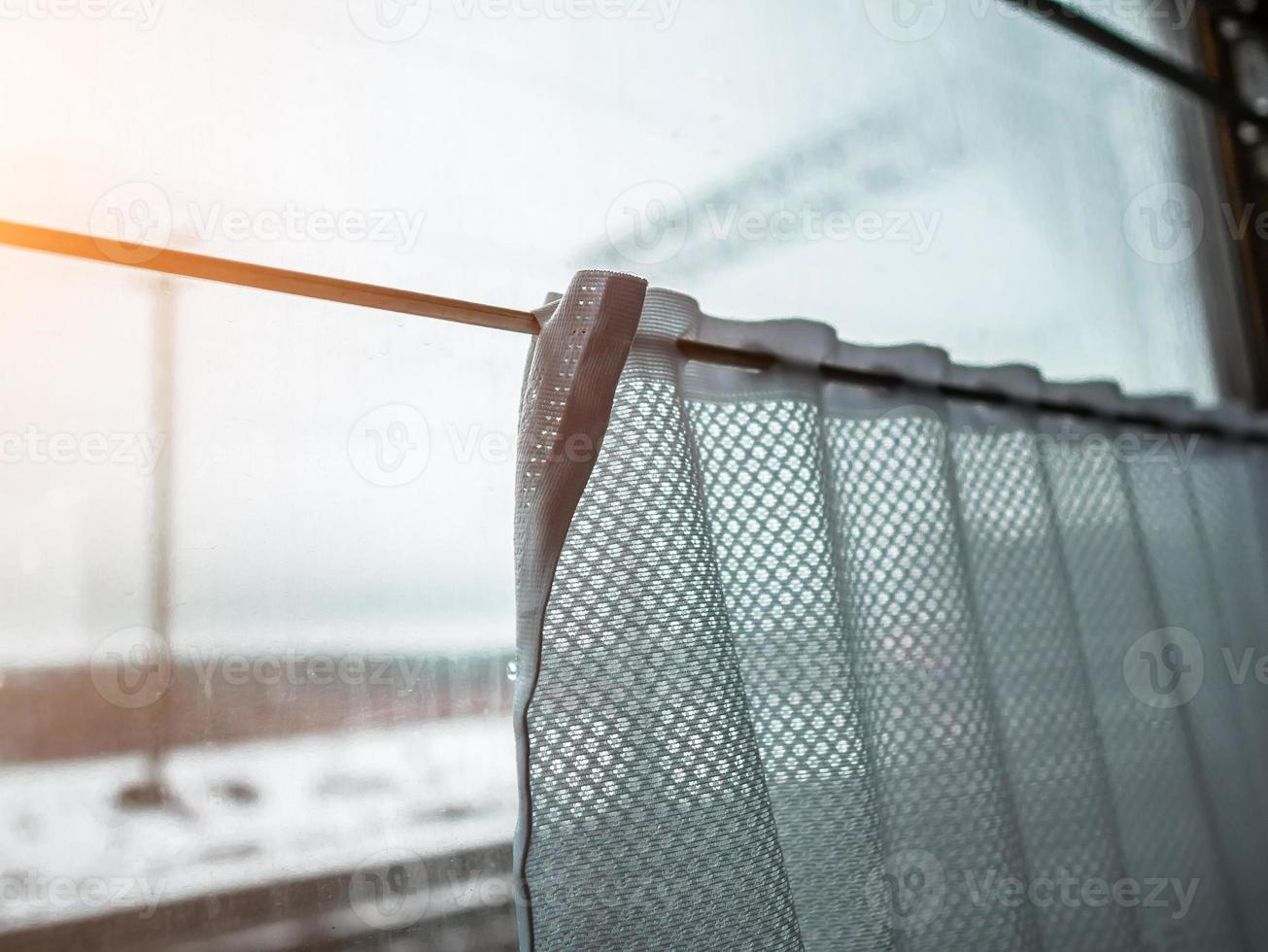 view from train window. The curtain on the window photo