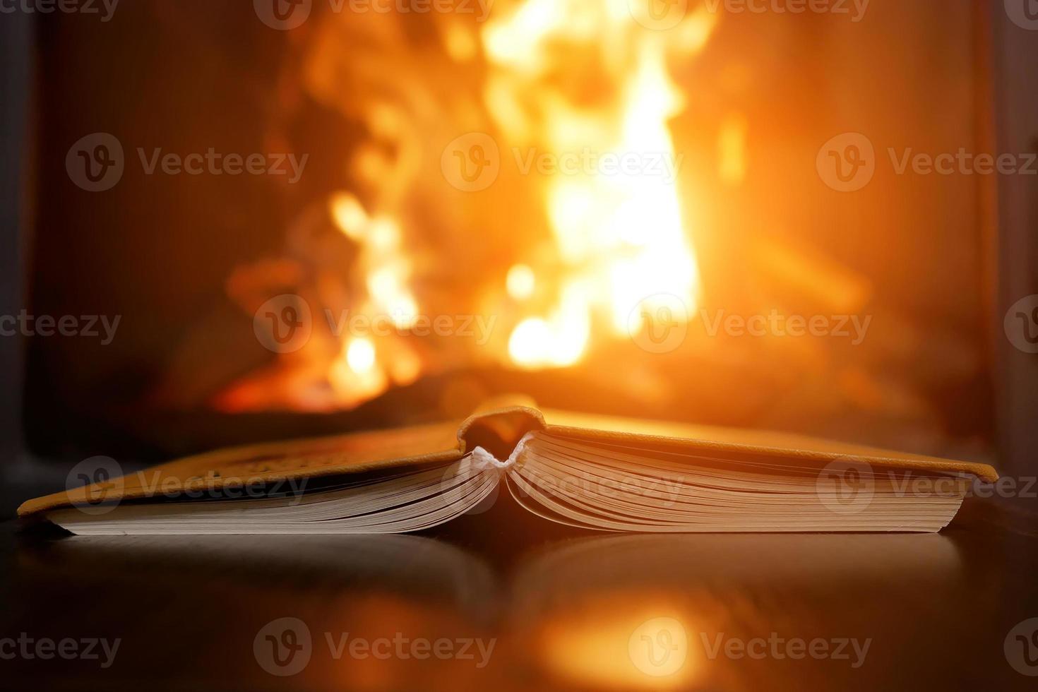 an open book next to the fireplace photo