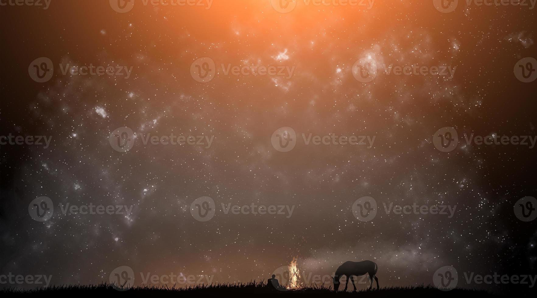 silhouette of a man and a horse against the background of the starry sky photo