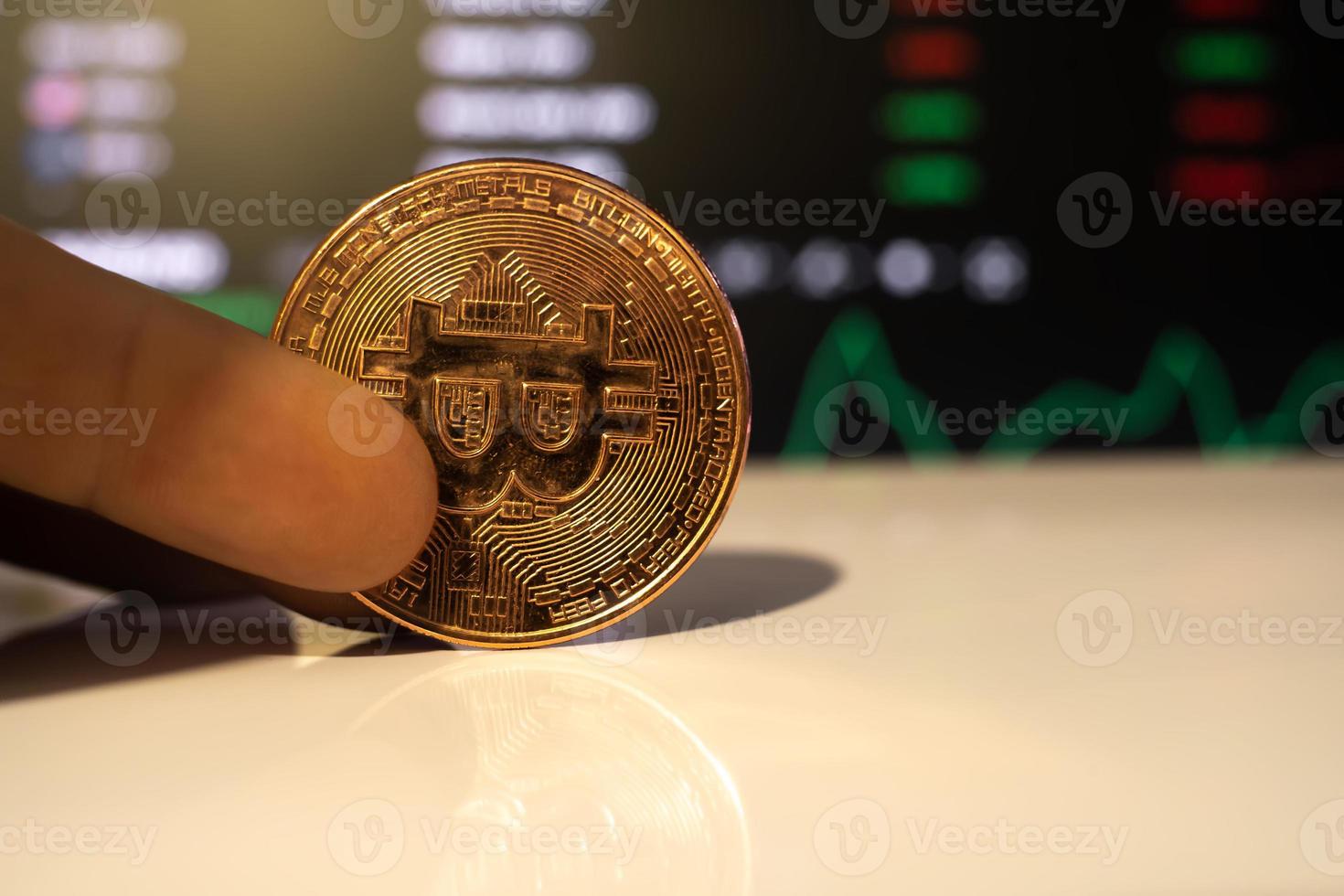 bitcoin coin on the background of exchange charts of currencies photo