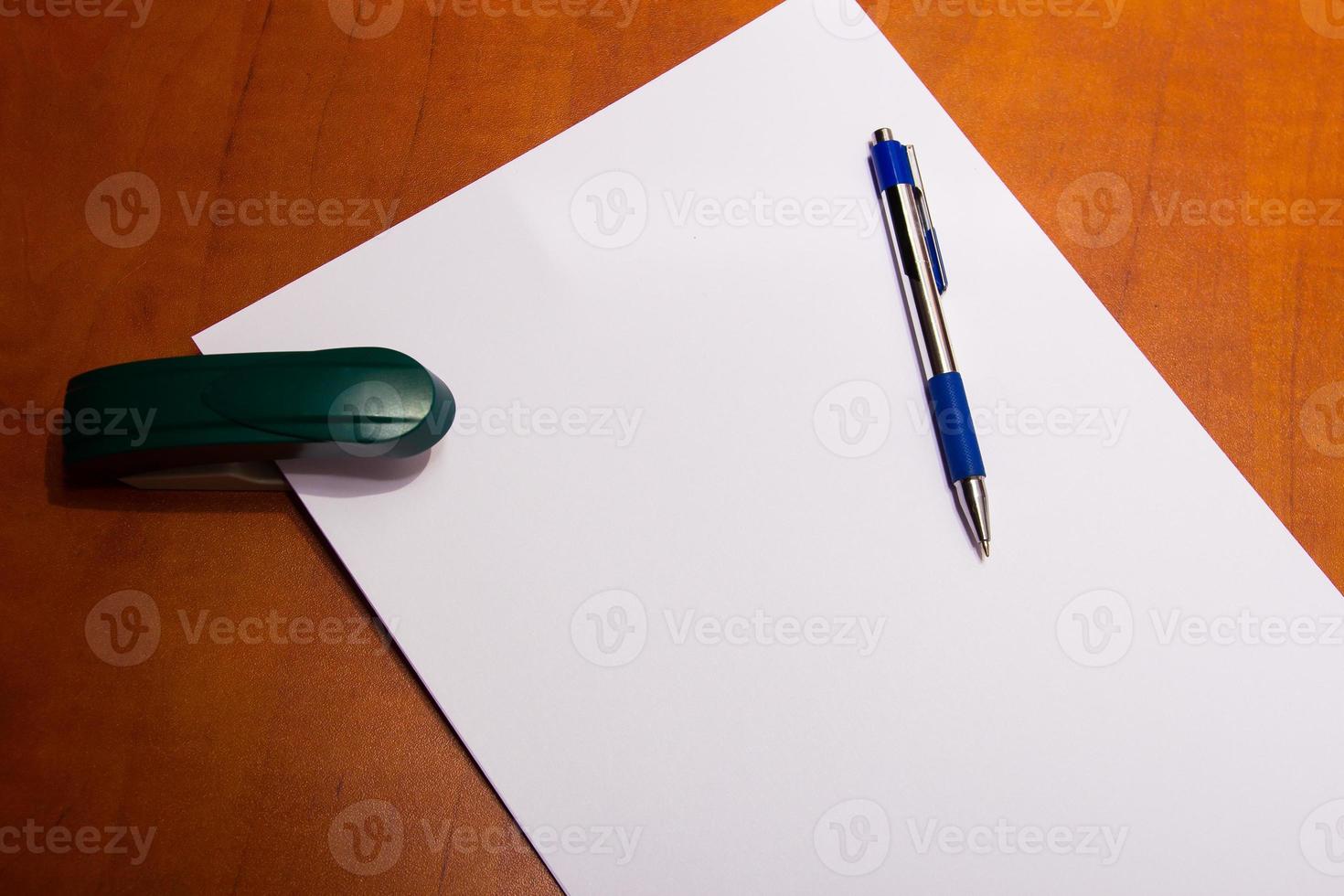 stapler and a sheet of paper photo