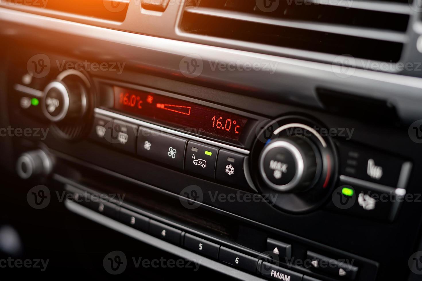 Temperature display on the car's climate control panel in a blurry background photo