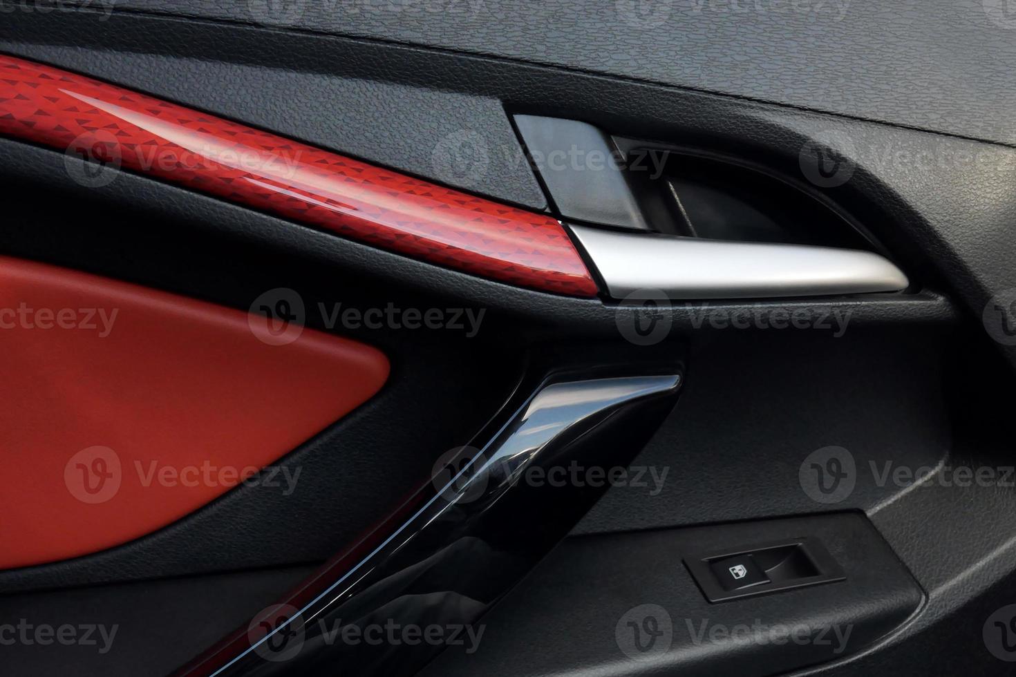 Car door panel closeup. luxury car interior from the inside. Door handle. photo