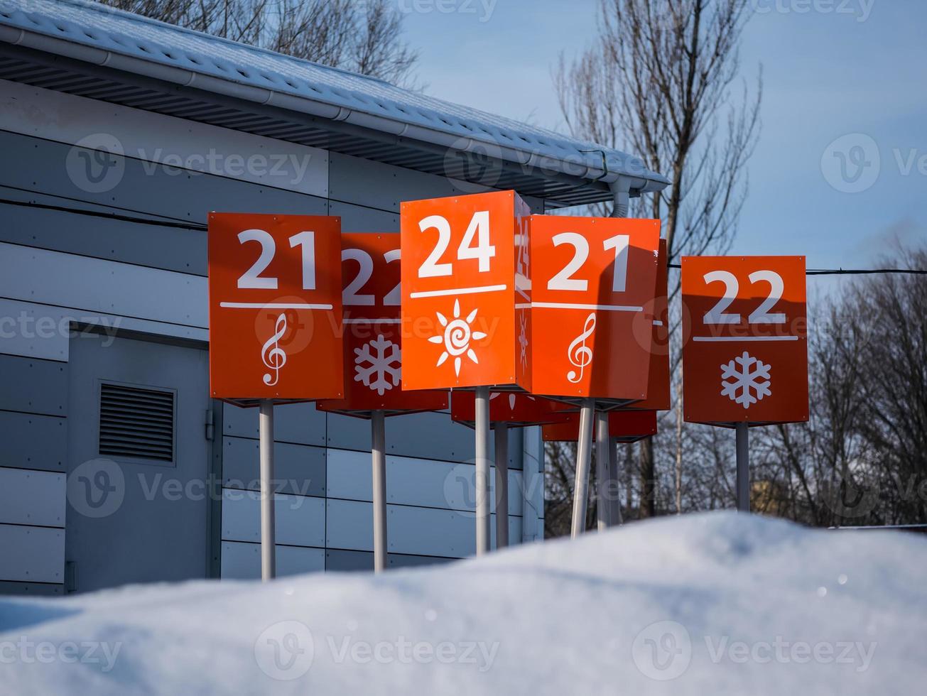 Orange signs are in the Parking lot of the store photo