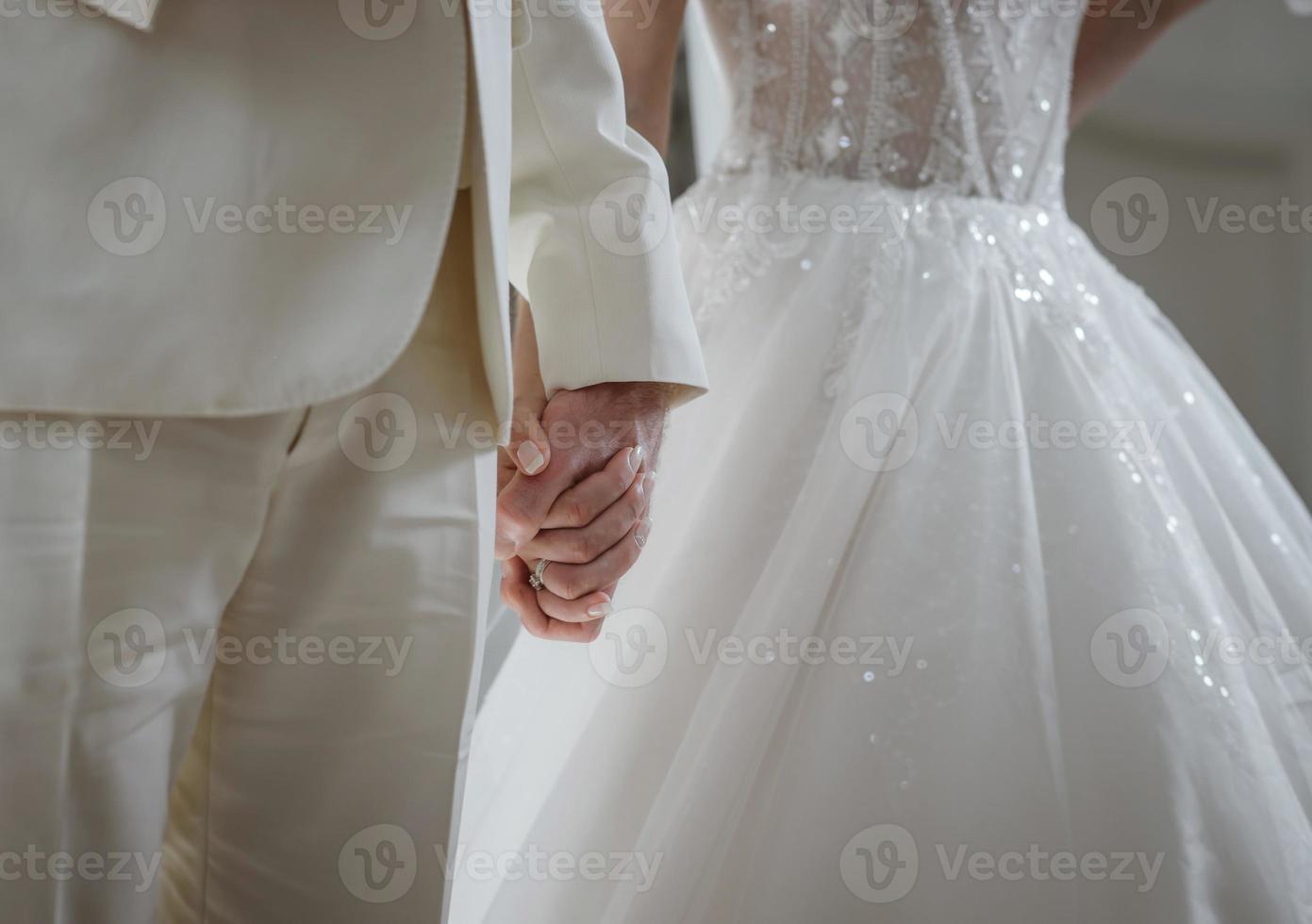 Delicate details of the wedding celebration. Newlyweds hold hands. photo