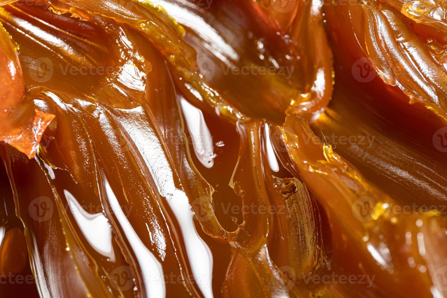 Close up of orange colored industrial grease. Rich and thick texture of industrial grade grease used to smooth out all metal friction. Lubricating grease. close-up of yellow lithium grease for machine photo