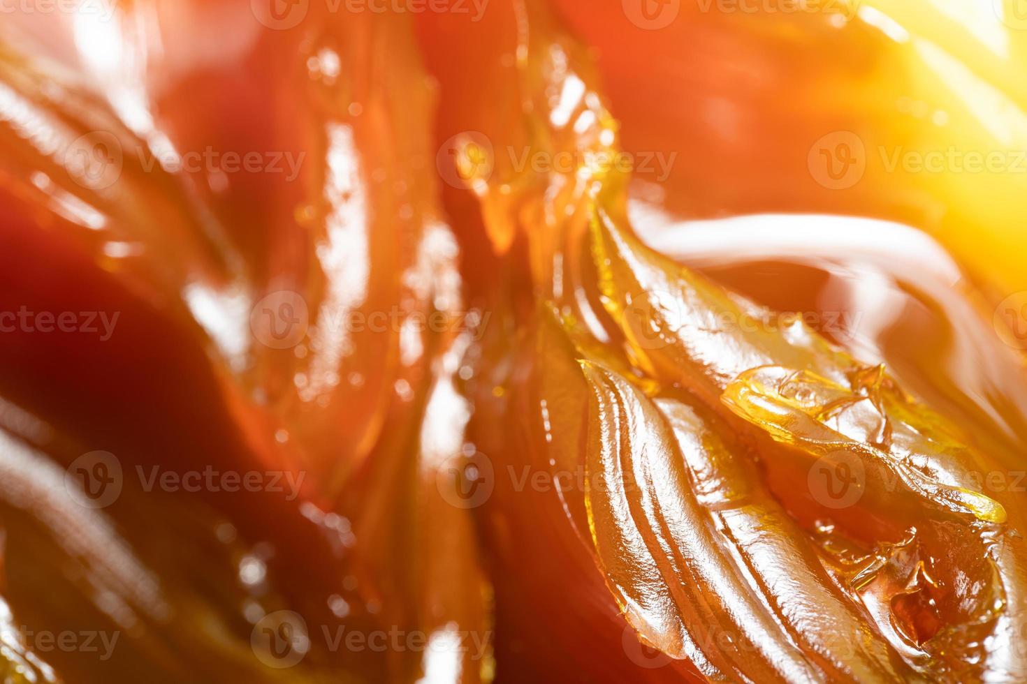 Close up of orange colored industrial grease. Rich and thick texture of industrial grade grease used to smooth out all metal friction. Lubricating grease. close-up of yellow lithium grease for machine photo