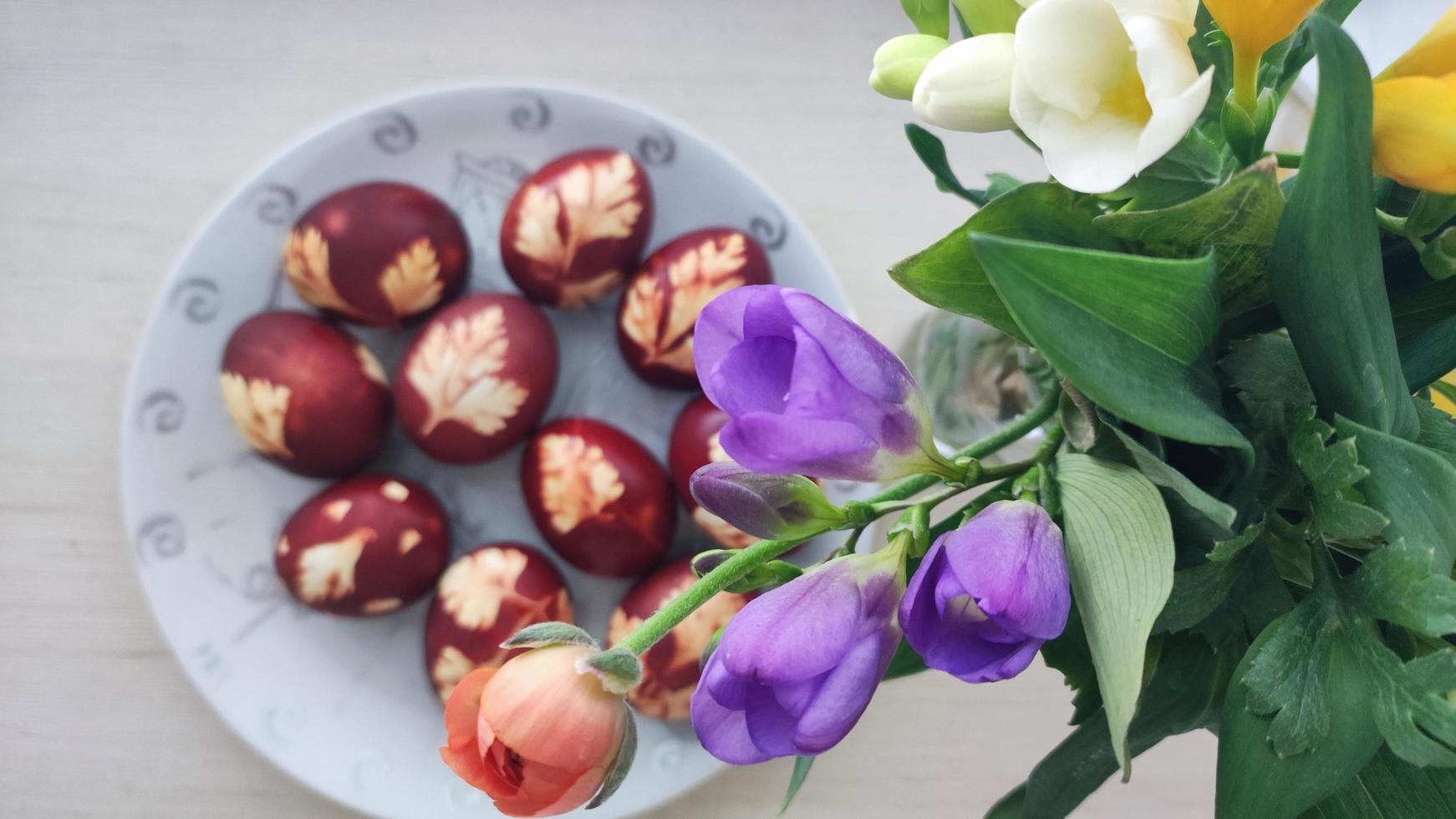 Easter eggs in nest and cherry blossom. Spring greeting card with copy space. Top view flat lay photo