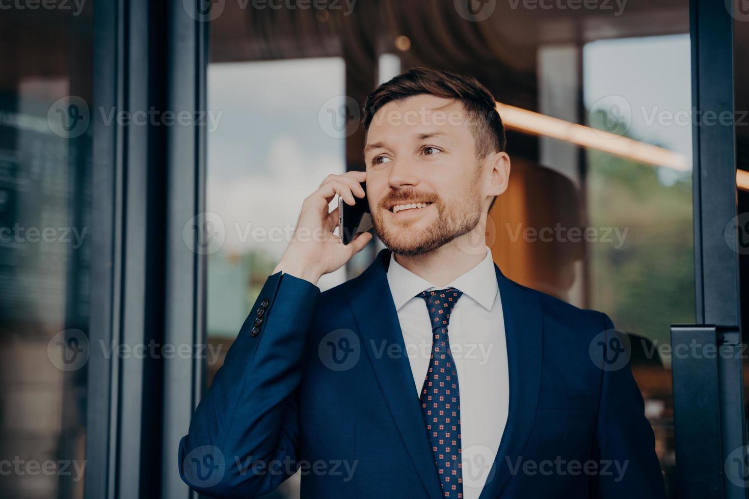 Male business owner hearing good news over phone photo