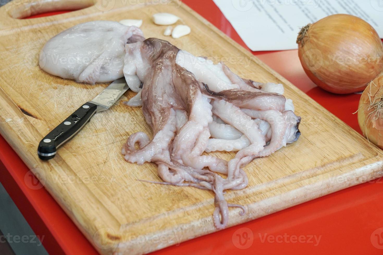 preparing fresh raw octopus or calamari photo