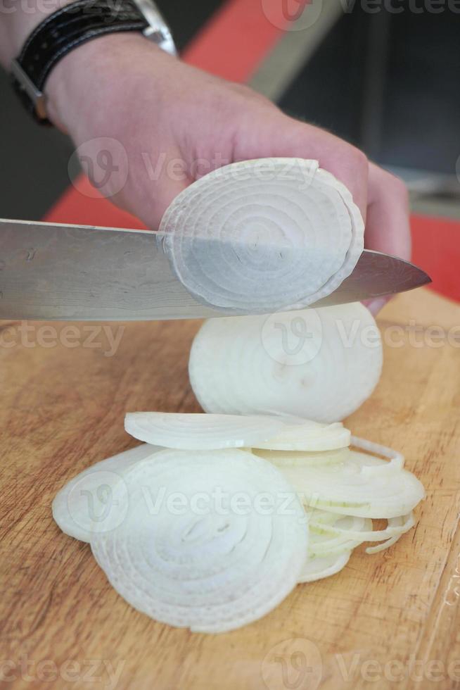 cutting onion in thin slices photo