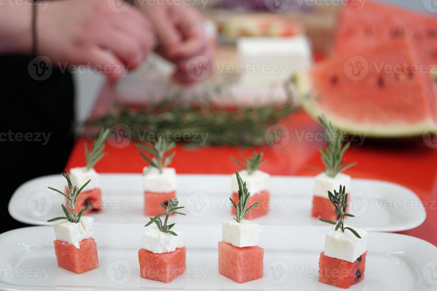 preparing watermelon and feta cheese cubes photo