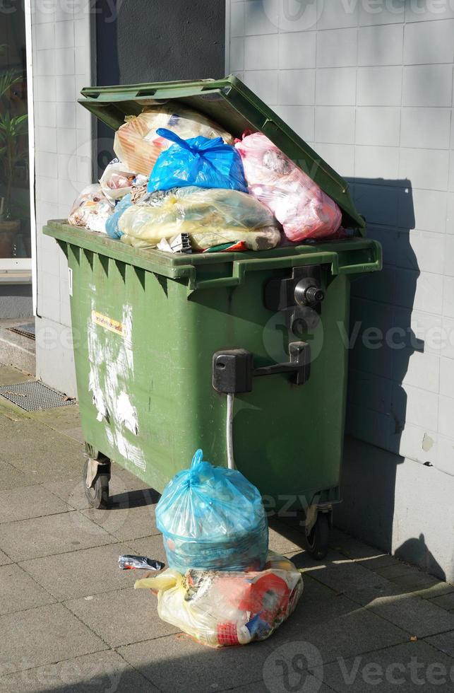 overflowing garbage container photo