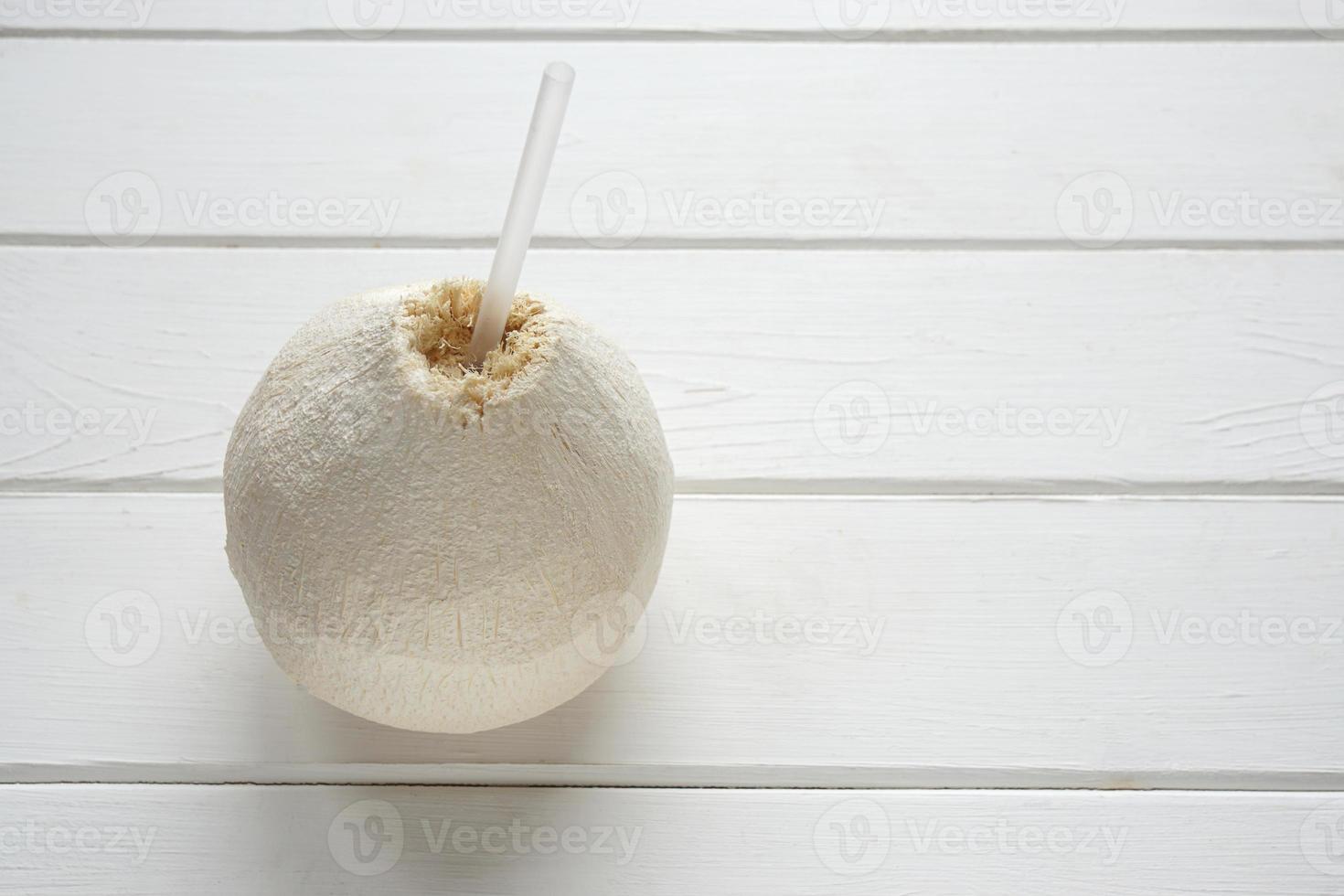 fresh coconut with drinking straw photo