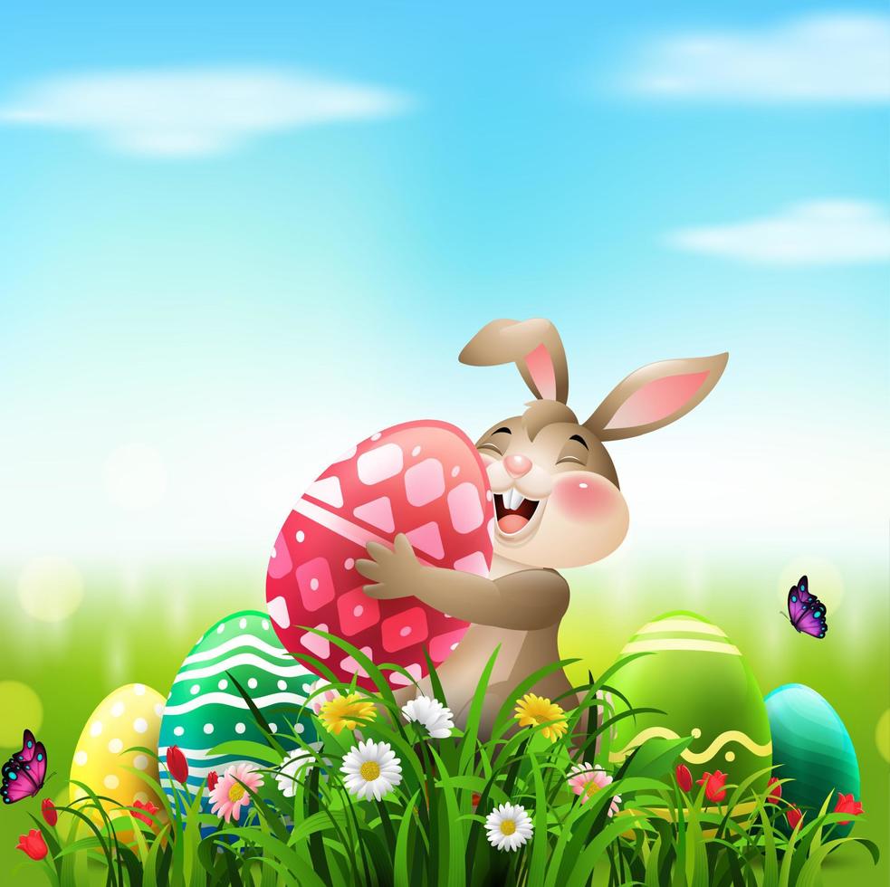 Happy Easter. Cute Easter bunny with huge eggs in the grass