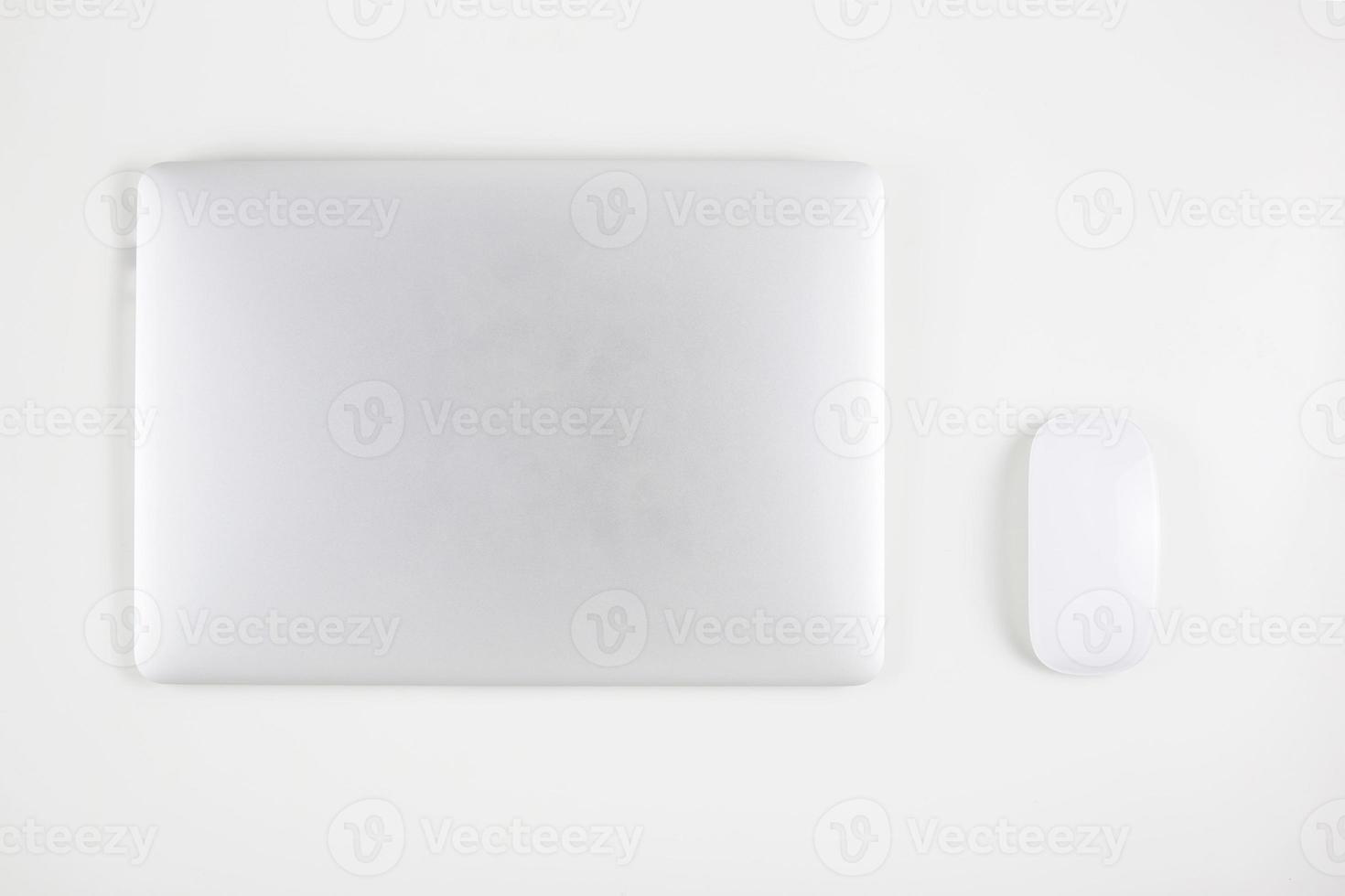 Top view of laptop computer with closed and mouse isolated on white background, notebook or netbook, communication technology concept. photo