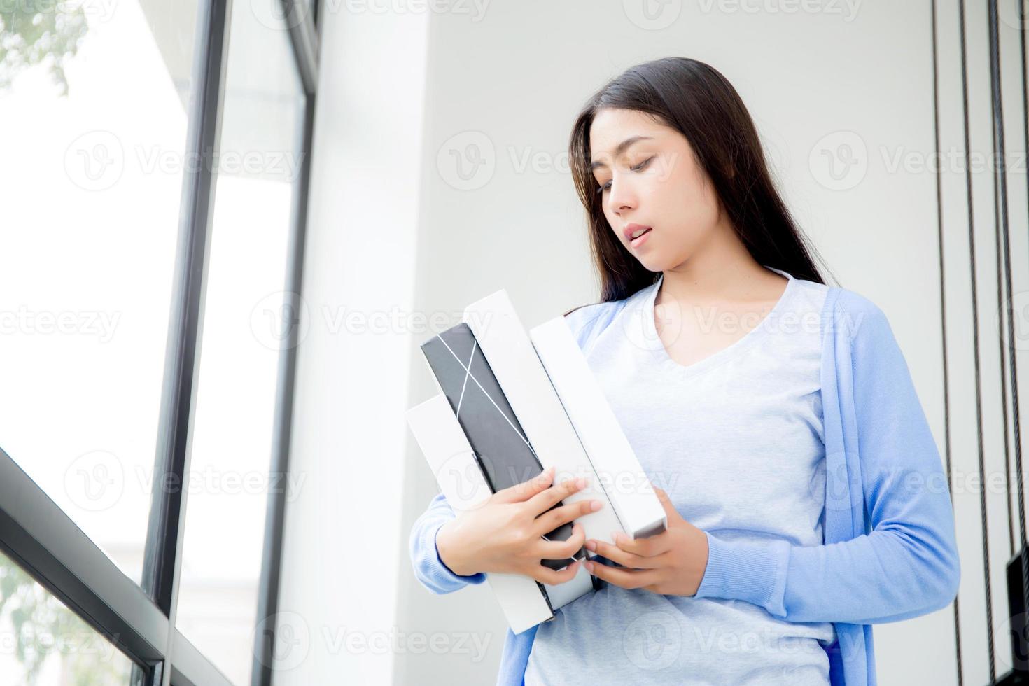 beautiful portrait young asian woman study and learning book for knowledge, girl holding book for research and searching at coworking college or university, education and lifestyle concept. photo