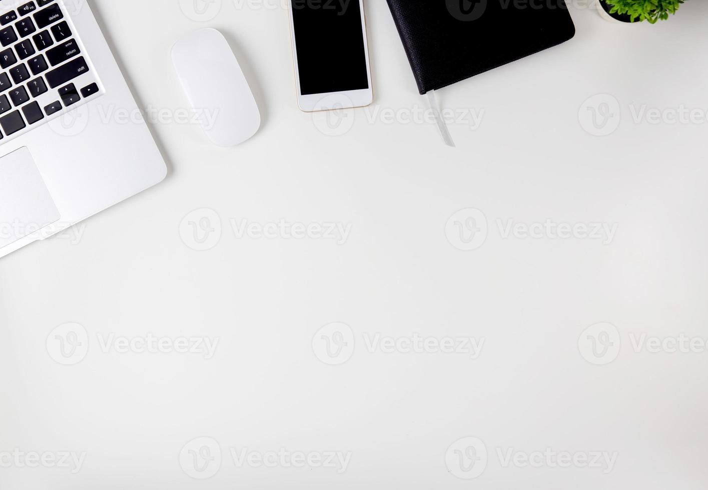 Top view of laptop computer with open display screen monitor, mouse and notepad and book and smart mobile phone isolated on white background, communication technology on work office concept. photo