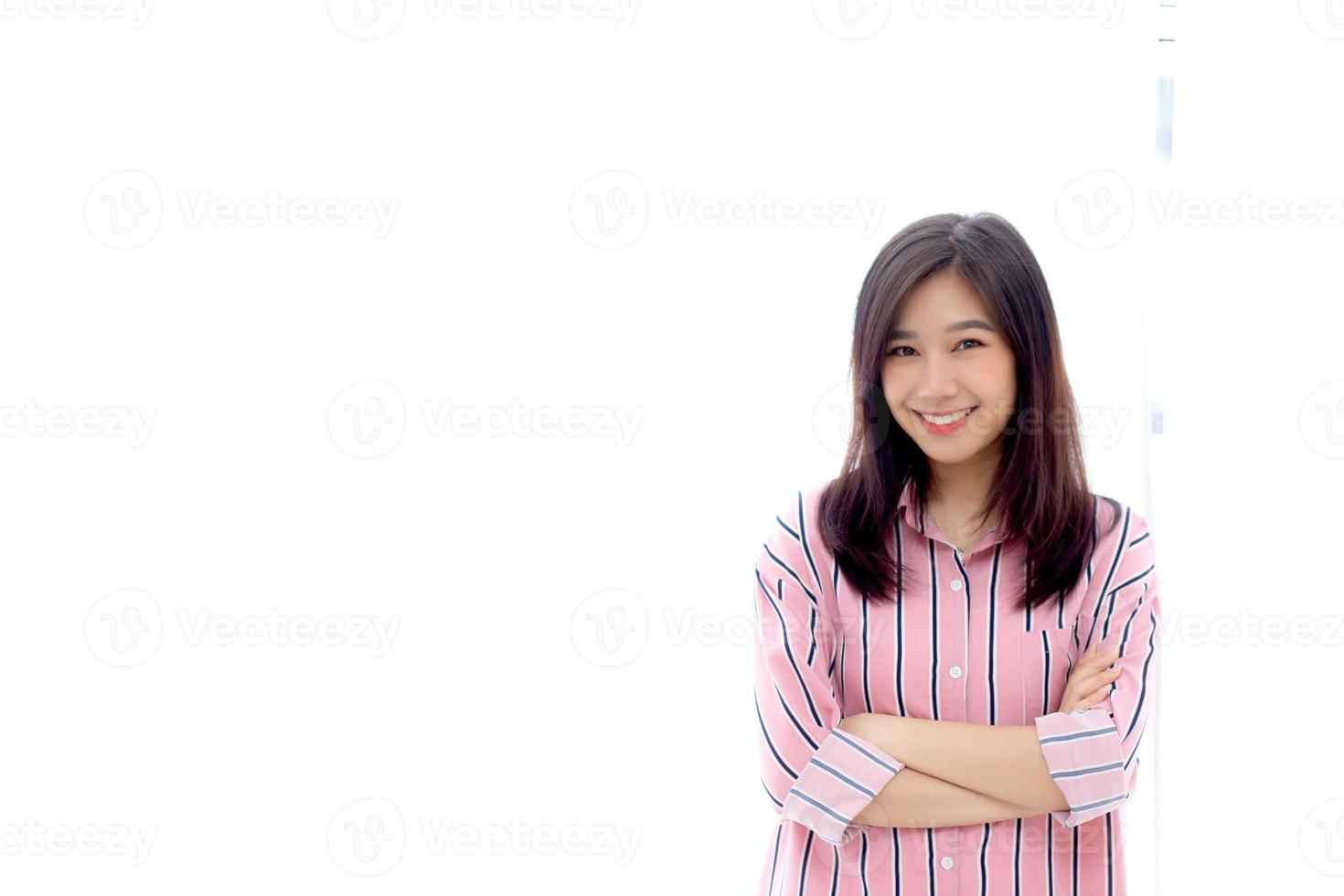 Portrait of beautiful young asian woman standing the window and smile while wake up with sunrise at morning, lifestyle and relax concept. photo